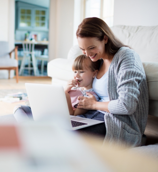 A parent and child looking at a laptop