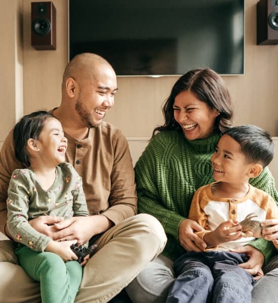 A family sitting on the floor laughing